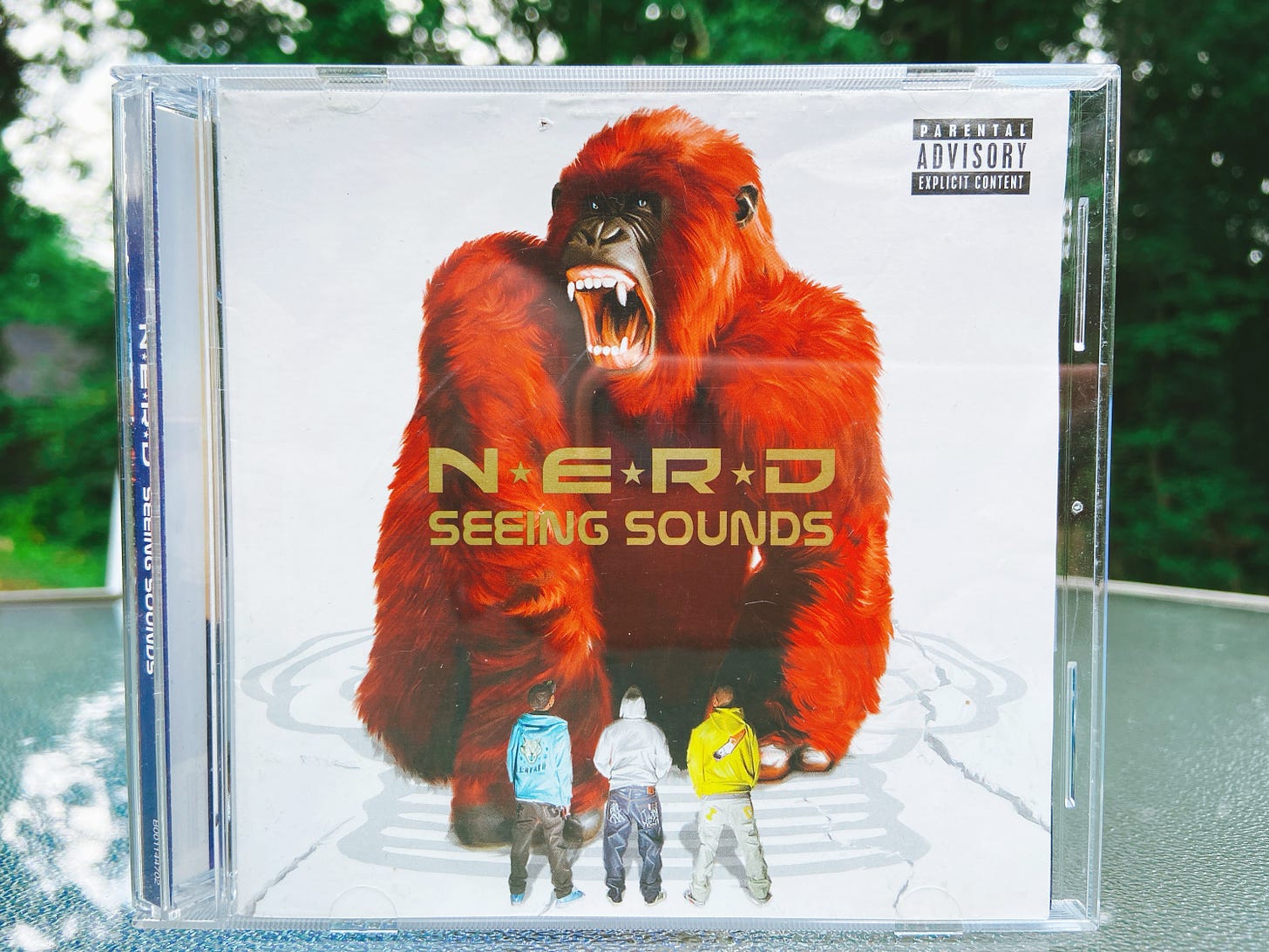 the Seeing Sounds album cover, which features the group N.E.R.D. staring at a large red gorilla