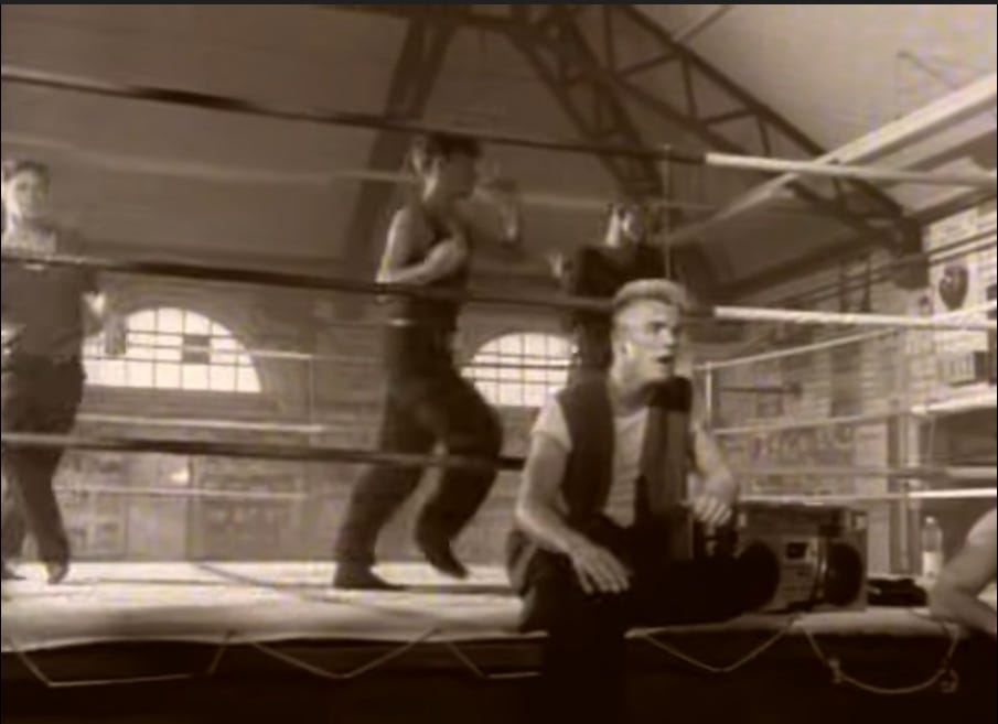 Fully clothed Take That in a boxing ring