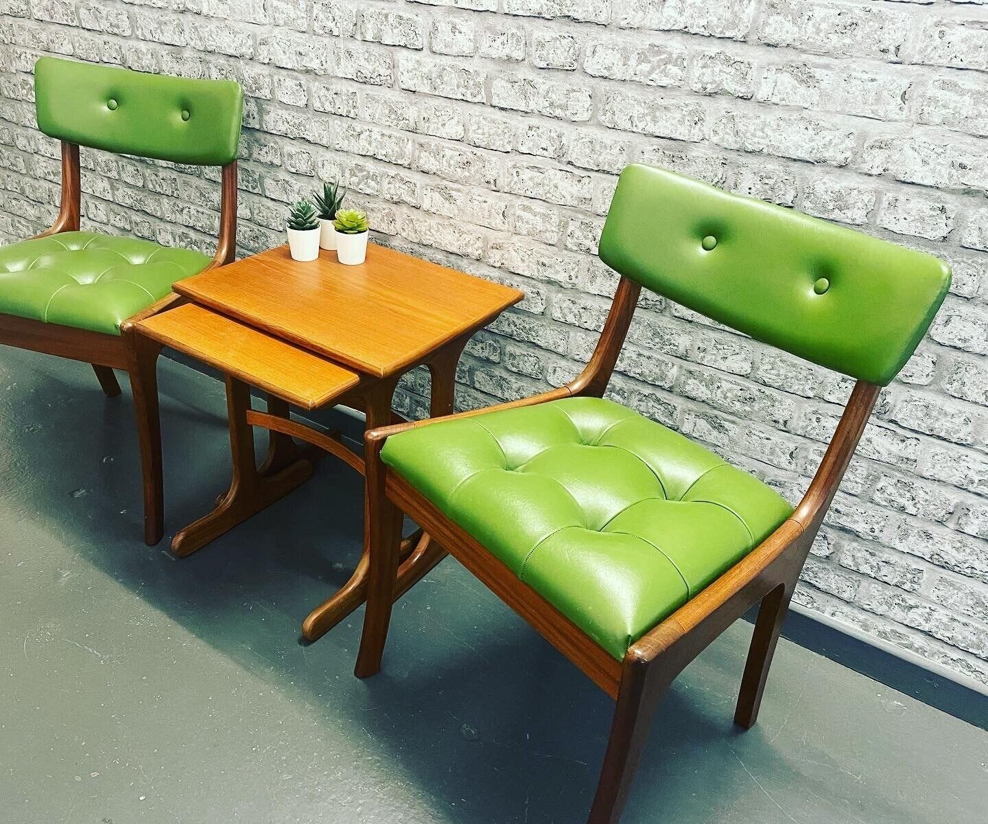 Two midcentury modern chairs with brown wood frames and glossy lime green upholstery