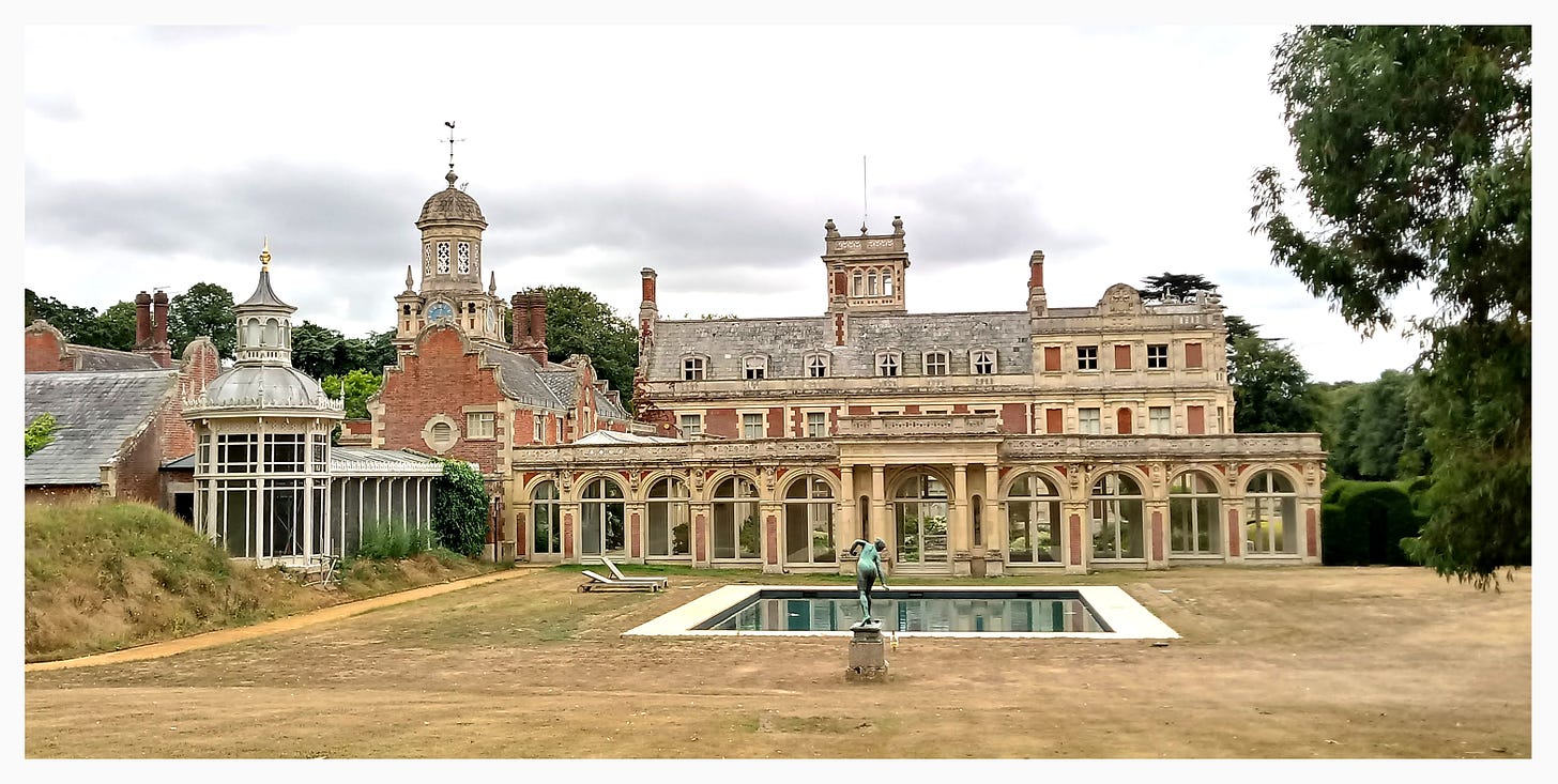 Somerleyton Hall in 2022, lawns sun-bleached after the long, hot summer. (Note the scaffold on the aviary (left), and the glass dome over the sunken garden long gone.)