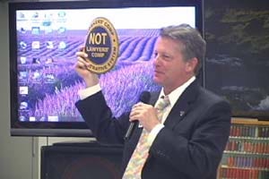 Costello holds logo promoting "Workers Comp Not Lawyers Comp"