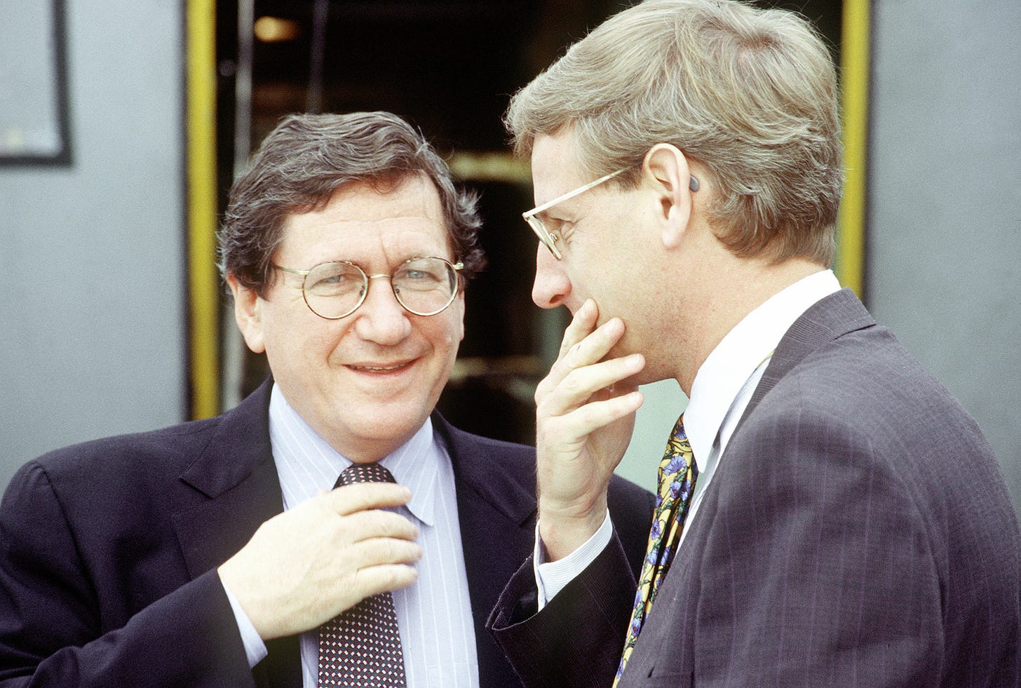 U.S. Assistant Secretary of State Richard Holbrooke (left) and Carl Bit  discuss upcoming events while waiting for a C-130 Hercules aircraft which  will fly the diplomats into Sarajevo, Bosnia-Herzegovina, for peace talks -