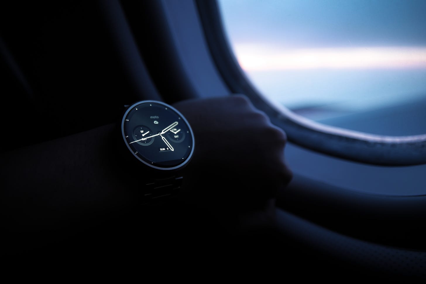 looking at an analog watch on a night flight