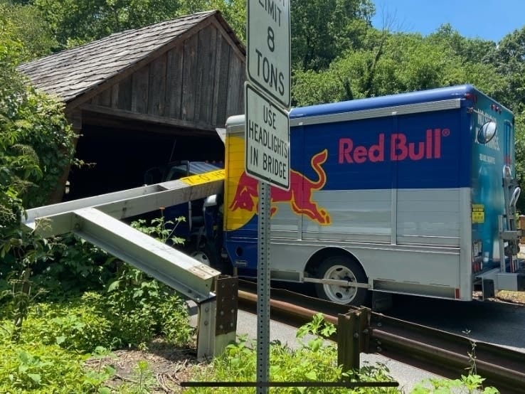 A Red Bull delivery truck driver tried to fit through the Covered Bridge in Smyrna, despite multiple warning signs that the truck was too tall. The driver slammed into the warning beam and knocked it over, but was not injured in the crash.