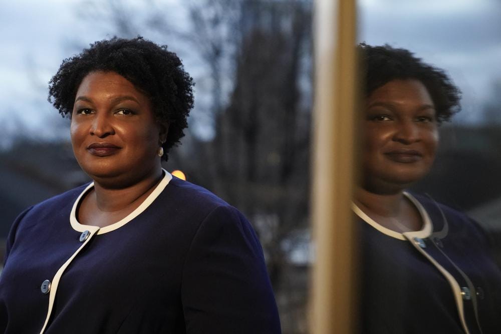 Georgia gubernatorial Democratic candidate Stacey Abrams poses for a photo during an interview with The Associated Press on Thursday, Dec. 16, 2021, in Decatur, Ga. Abrams is calling on Congress to act on voting rights as the Democrat launches a second bid to become her state's governor.  (AP Photo/Brynn Anderson)