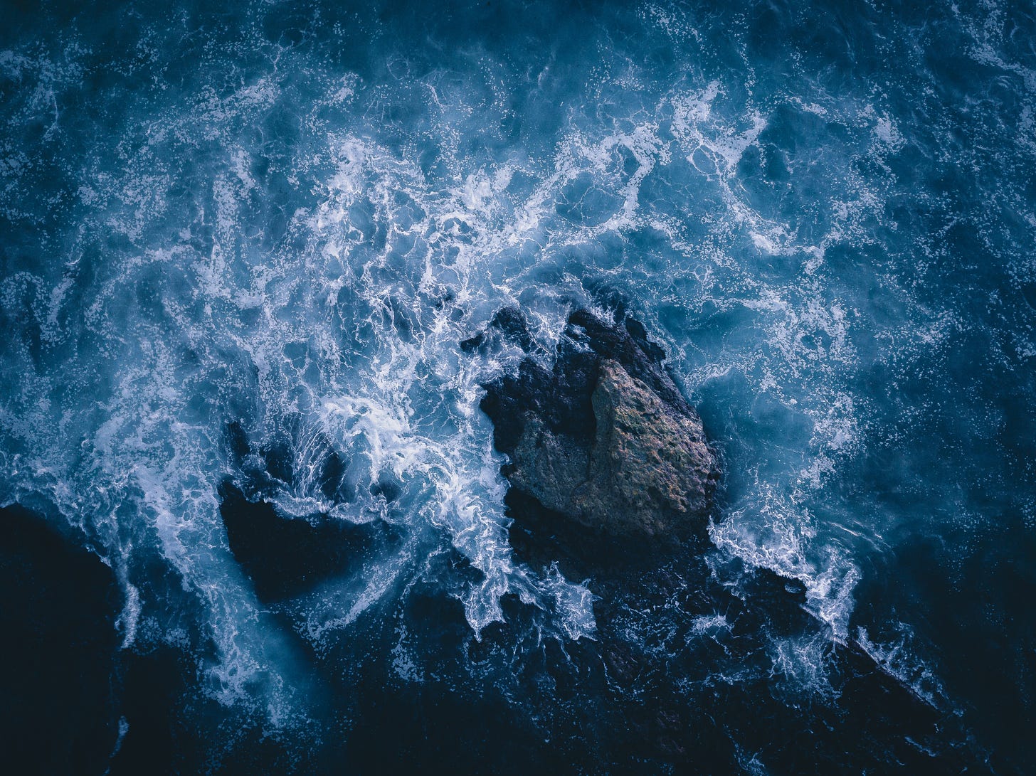 ocean crashing around rock