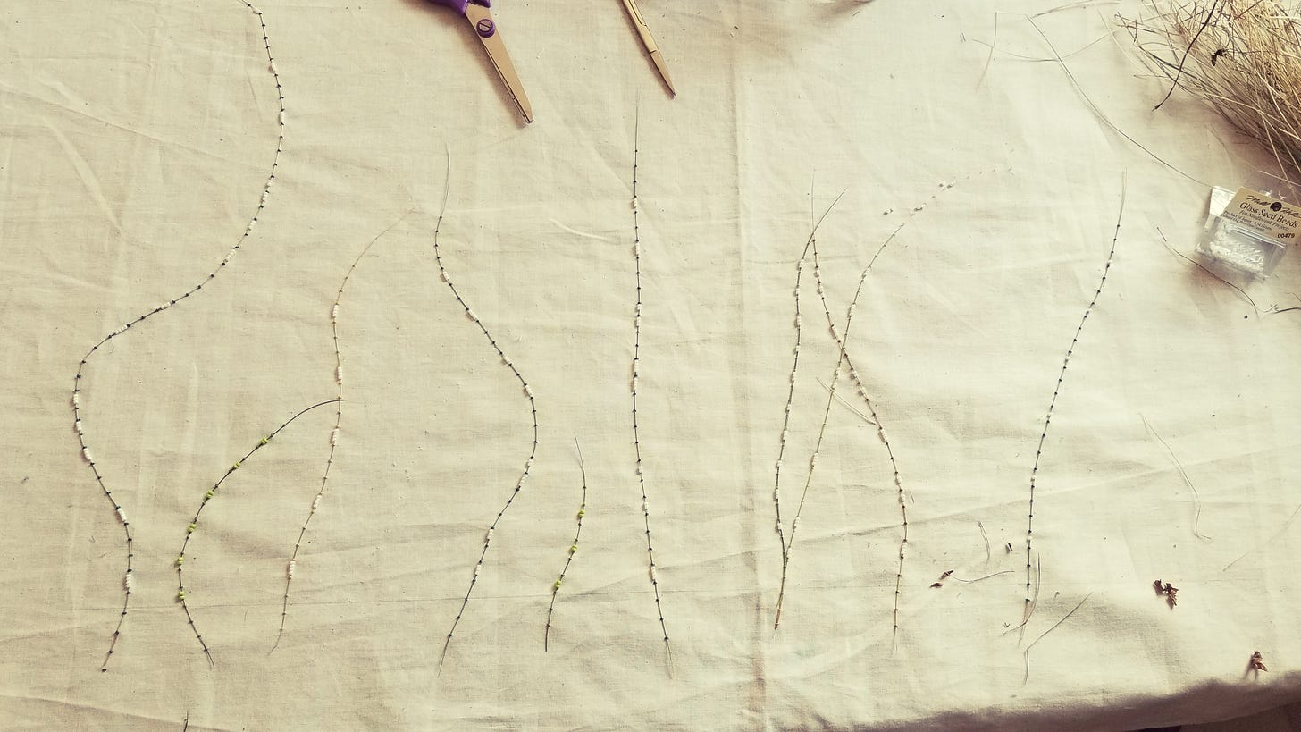 Large muslin fabric with grass and glass beads couched onto it, very wrinkly