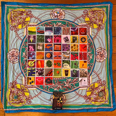 45+ cards laid in a grid on a colorful silk scarf. The cards are from a Rainbow Squared deck with images from Year 2, each one laid out in the order that I drew them this year. This is the spread for this week’s reading, Piece Forty-Five of Rainbow Squared Year 5.