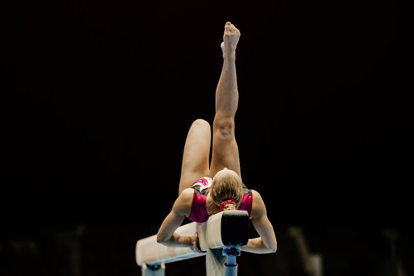 Girl performing on balance beam