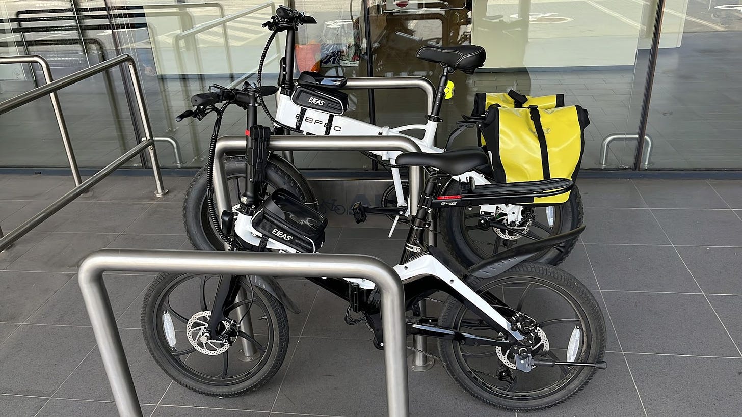 Two EBFEC folding e-bikes, locked on a bike rack