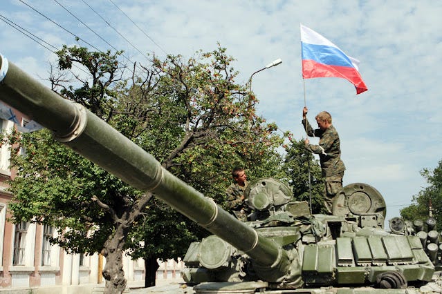 Russian%20soldiers%20place%20a%20Russian%20flag%20atop%20their%20tank%20in%20the%20South%20Ossetian%20town%20of%20Tskhinvali%20on%20August%2011,%202008.%20%C2%A9%20AFP