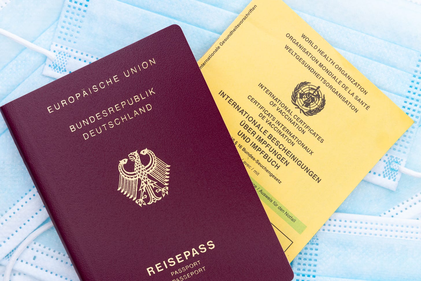 German passport next to WHO vaccine passport