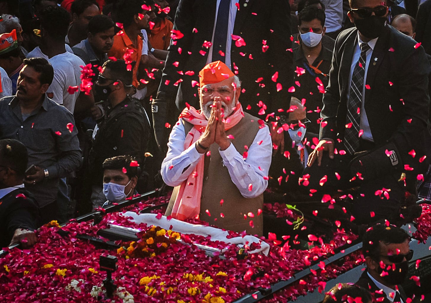 India's Prime Minister Narendra Modi greets crowds of supporters during a roadshow in support of state elections on March 04, 2022