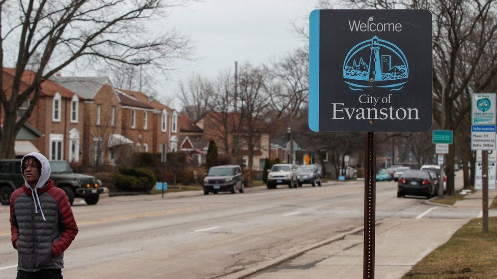 A man walks by a sign welcoming people to the city of in Evanston, Illinois, on March 16, 2021