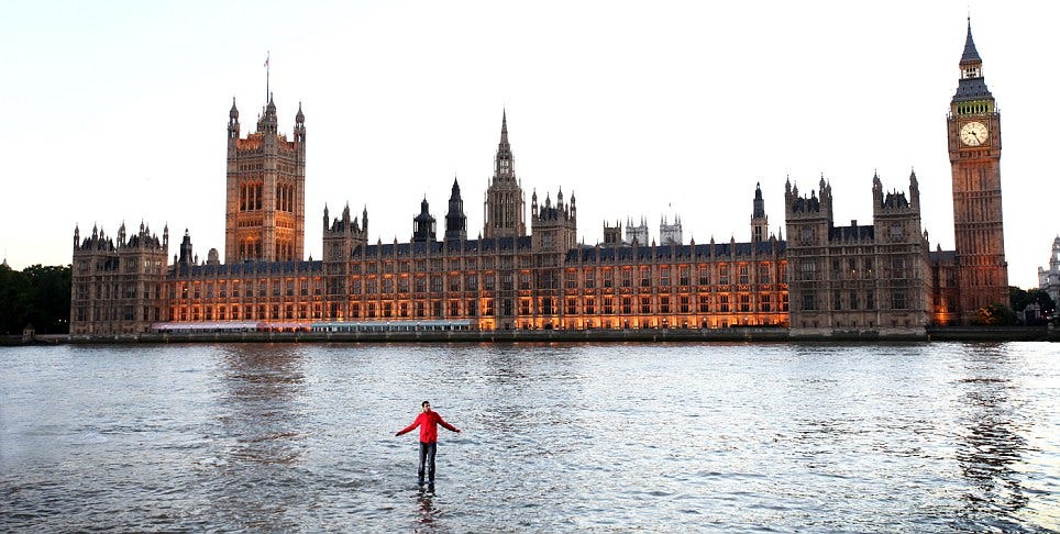 Biblical epic: Magician Dynamo poses while standing in the middle of the River Thames where he performed an illusion in which he appeared to walk on water