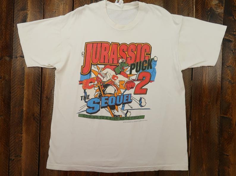 Vintage Calgary Flames NHL Jurassic Puck Single Stitch T-Shirt image 1