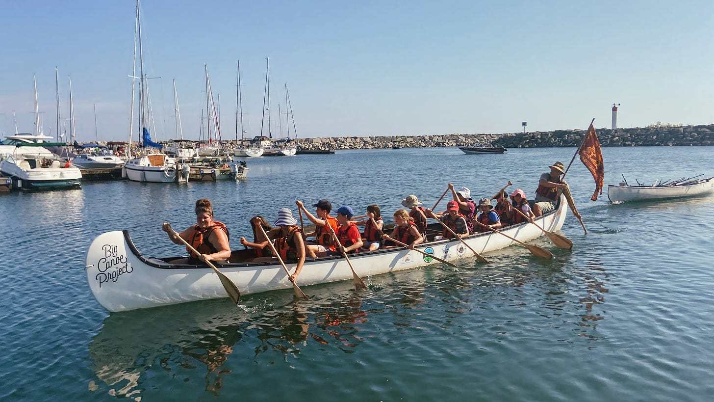 Canoe with adults and children rowing