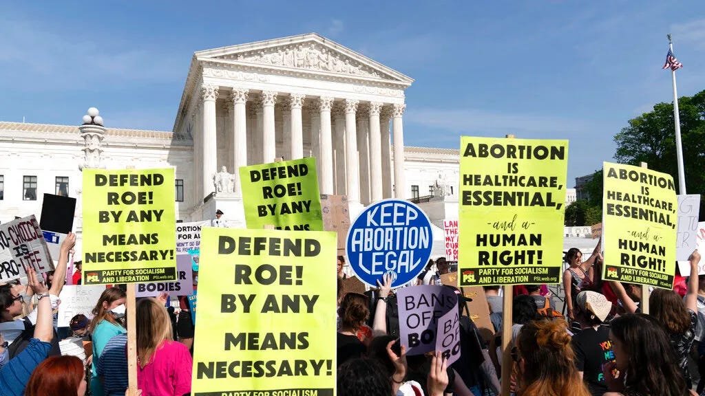 Protesters outside of a government building fighting for abortion rights.