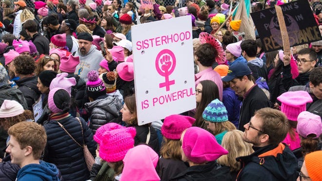 A sea of pink and homemade signs floods downtown D.C. streets at the Women's March on Washington the day after Donald Trump's inauguration as president of the United States.