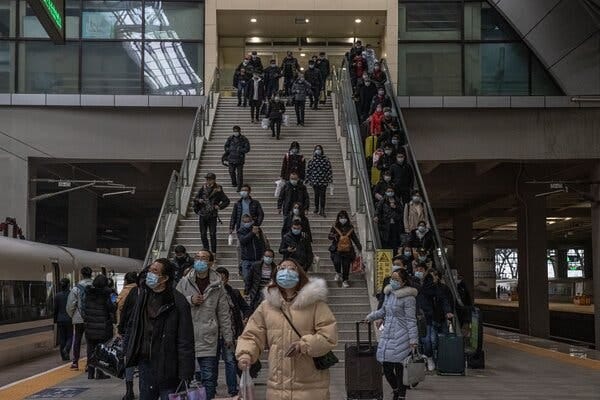 Passengers boarding a train last week at Hankou Station in Wuhan, China. A year ago, the station was among the first places to be closed as the government tried to contain the world’s first coronavirus outbreak.