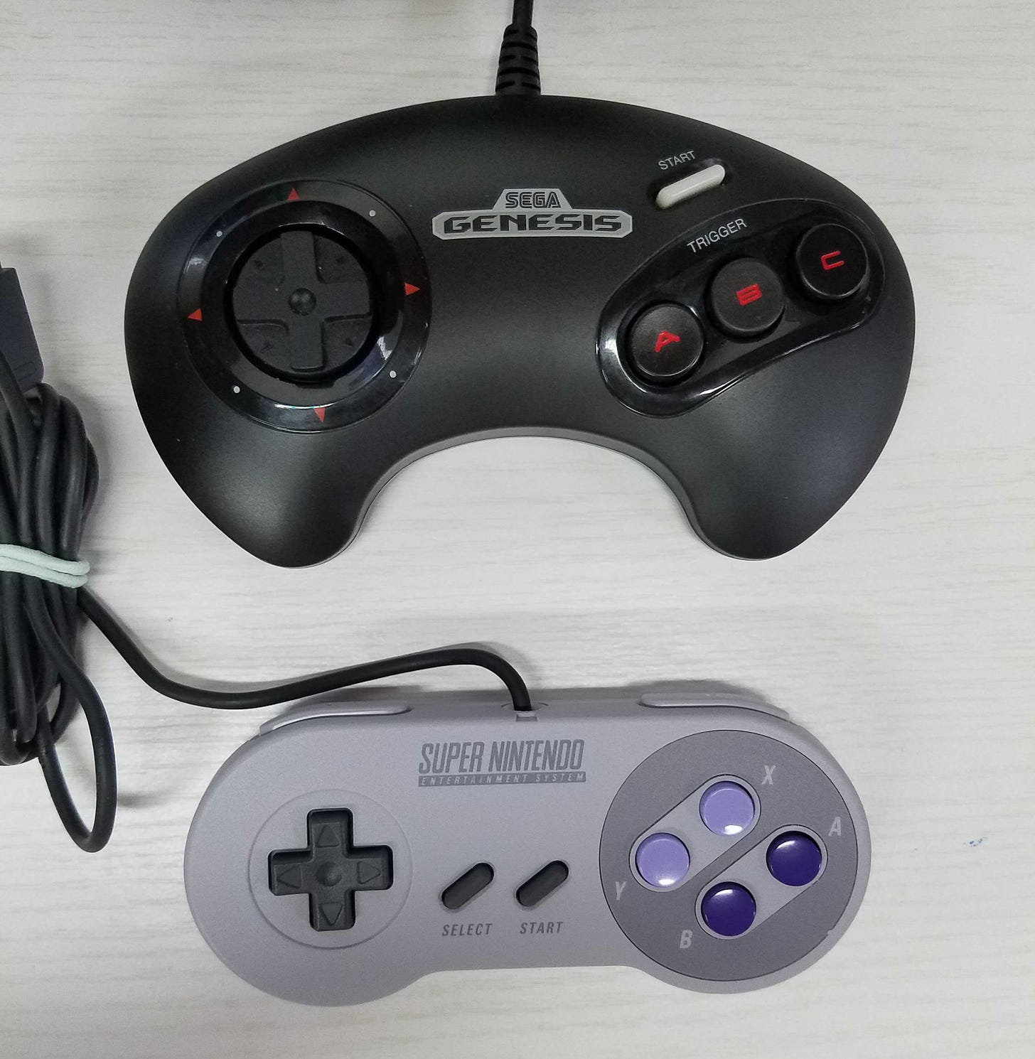 A Sega Genesis replica controller for the Genesis Mini, and a replica SNES controller for the SNES Mini