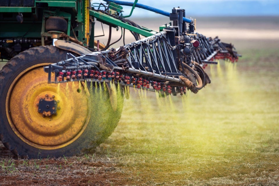 Image of tractor spraying pesticide.