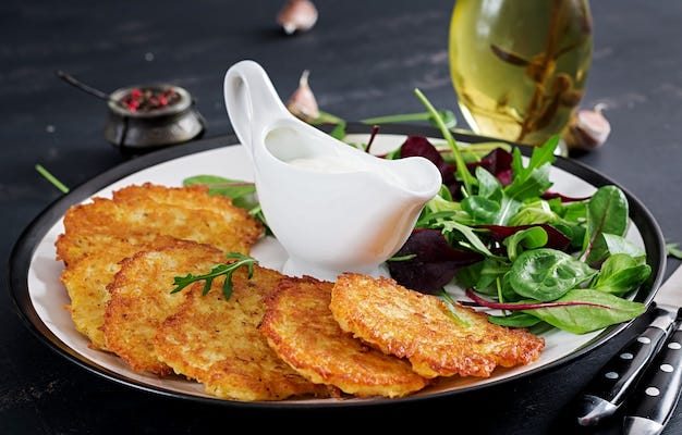 Potato fritters served with sour cream