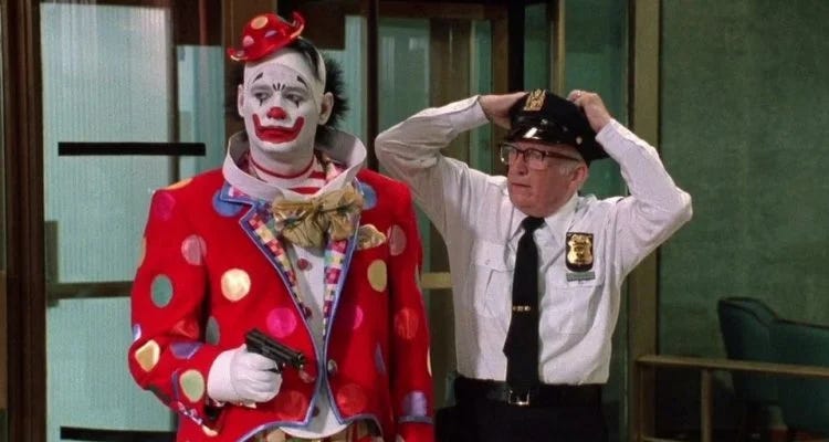Screenshot of Bill Murray wearing a clown suit and holding a gun in the film Quick Change