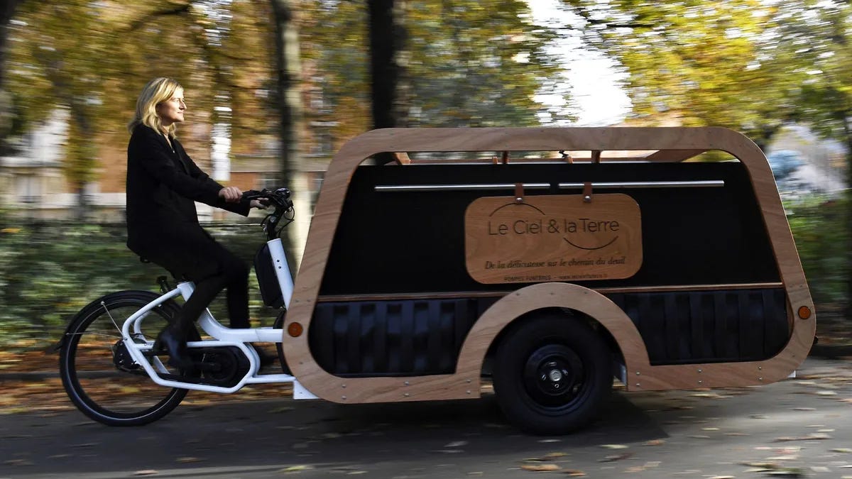 Isabelle Plumereau rides her "corbicyclette" bicycle hearse invented to accompany families in their mourning in a different way, in Paris on October 31, 2022.