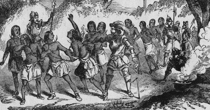 A group of enslaved Native Americans led by a Spaniard holding them in chains.