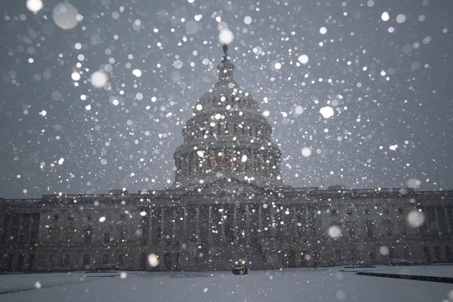 Snowflakes are seen falling in front of the U.S. Capitol building.