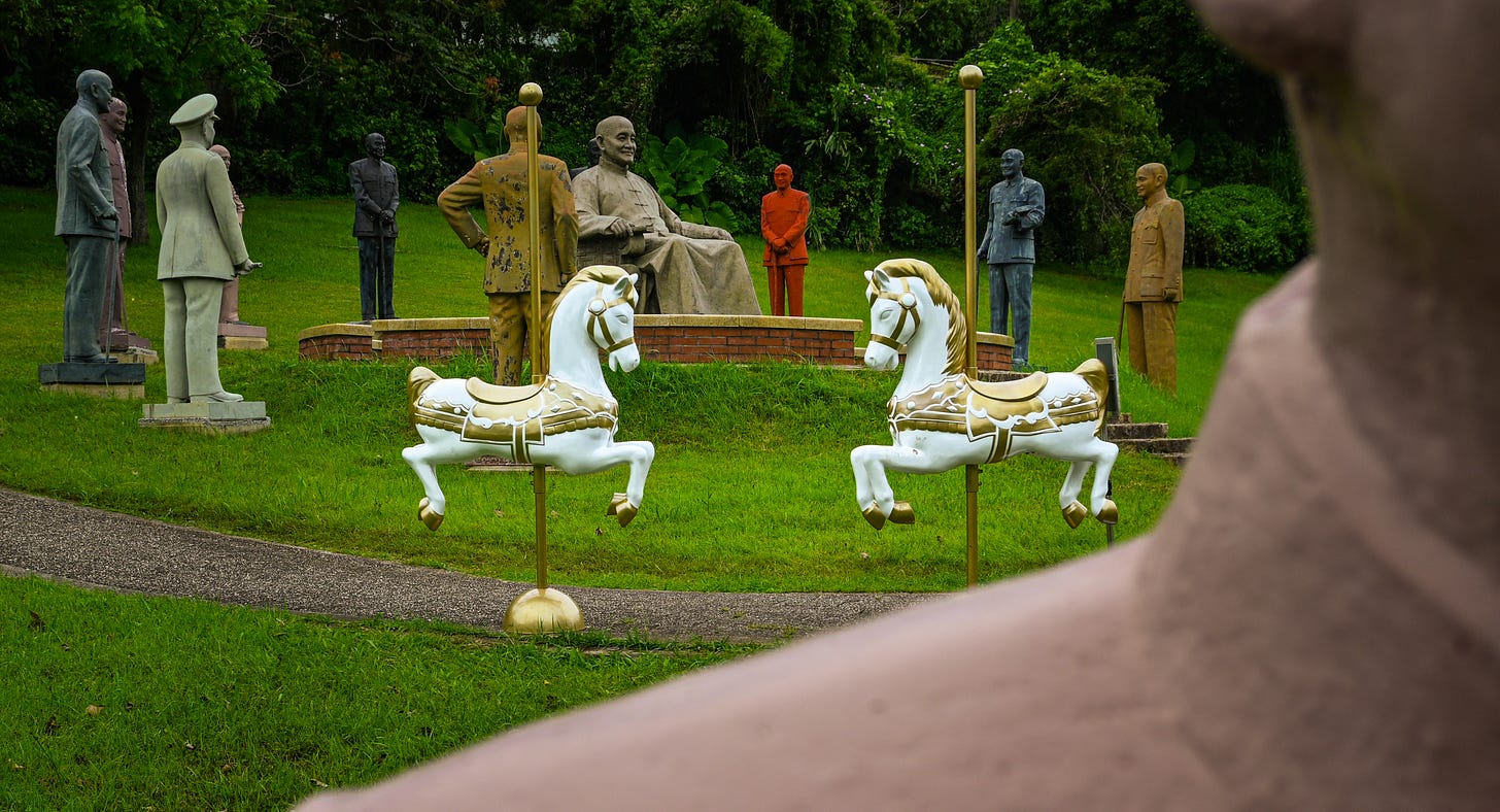 A pair of merry-go-round horses sit among Chiang Kai-shek statues during National Day festivities taking place at Cihu park A pair of merry-go-round horses sit among Chiang Kai-shek statues during National Day festivities taking place at Cihu park