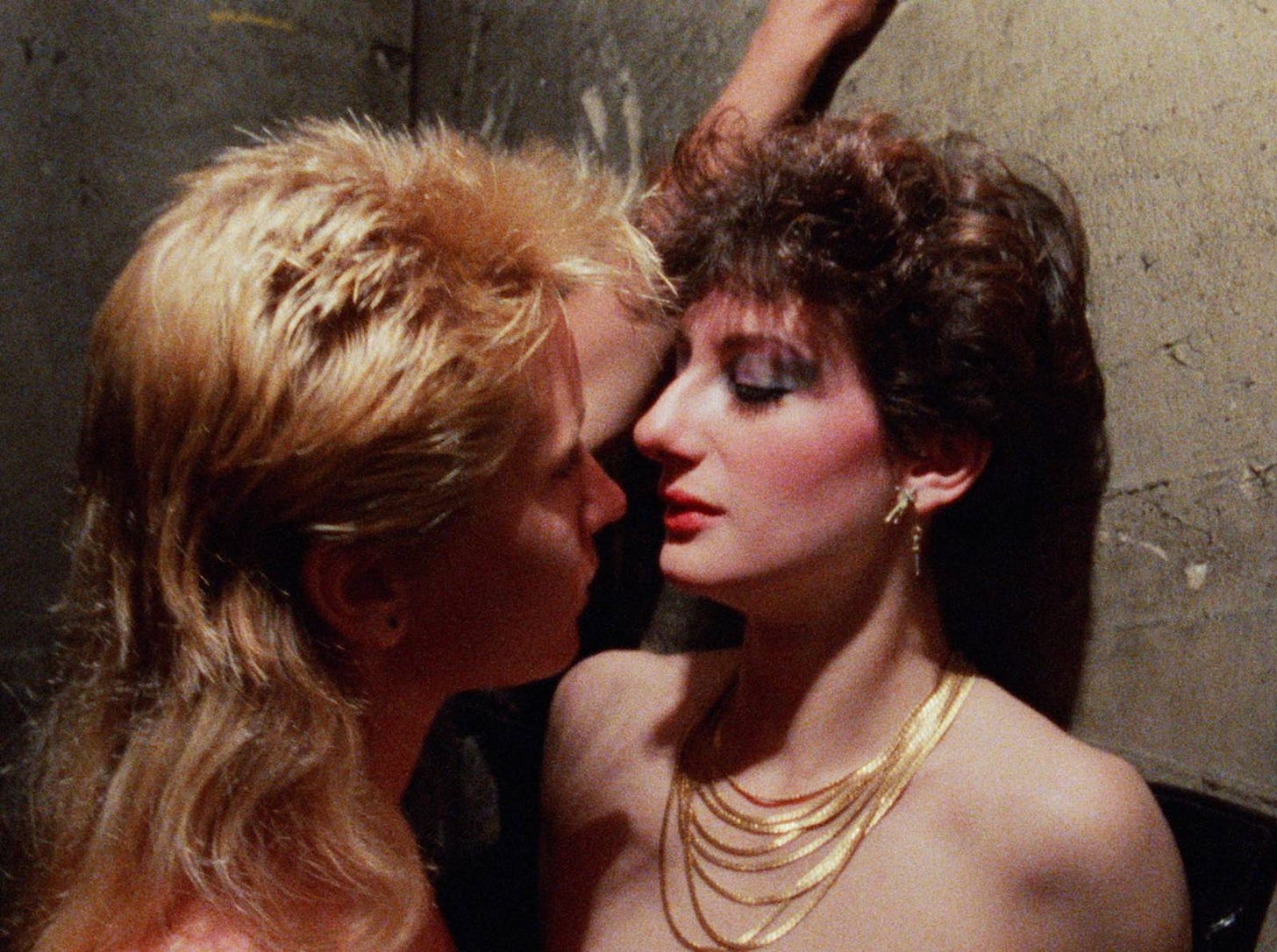Sharon Mitchell and her girlfriend Tigr get close enough to kiss in Kamikaze Hearts (1986)