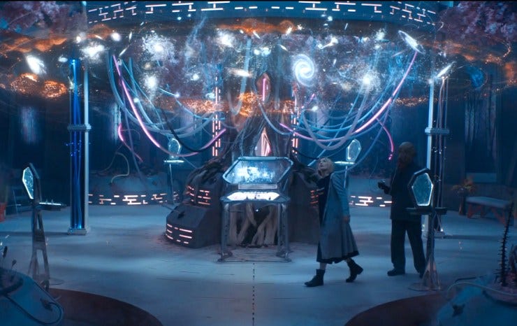 This image shows the Thirteenth Doctor (played by Jodie Whittaker) and a lone Ood (played by Simon Carew) walking beneath a holographic representation of the universe located inside Division's headquarters. This image shows the Thirteenth Doctor (played by Jodie Whittaker) and a lone Ood (played by Simon Carew) walking beneath a holographic representation of the universe located inside Division's headquarters.