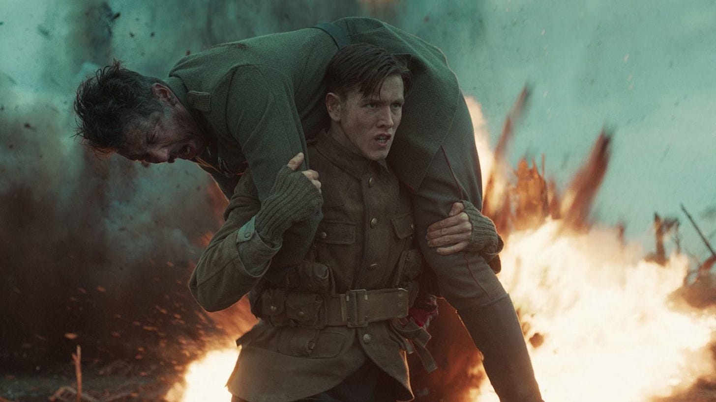 Conrad lifting an injured Union Jack soldier to friendly lanes while the enemy bombards them.