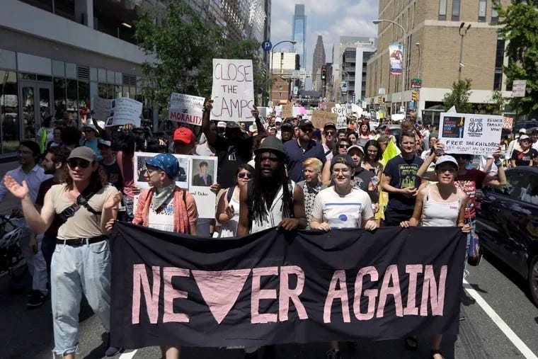 Protesters assembled by a majority Jewish group called "Never Again Is Now" walk through traffic as they make their way to Independence Mall. Hundreds gathered during Philadelphia's traditional Fourth of July parade to protest the treatment of immigrants and asylum seekers.