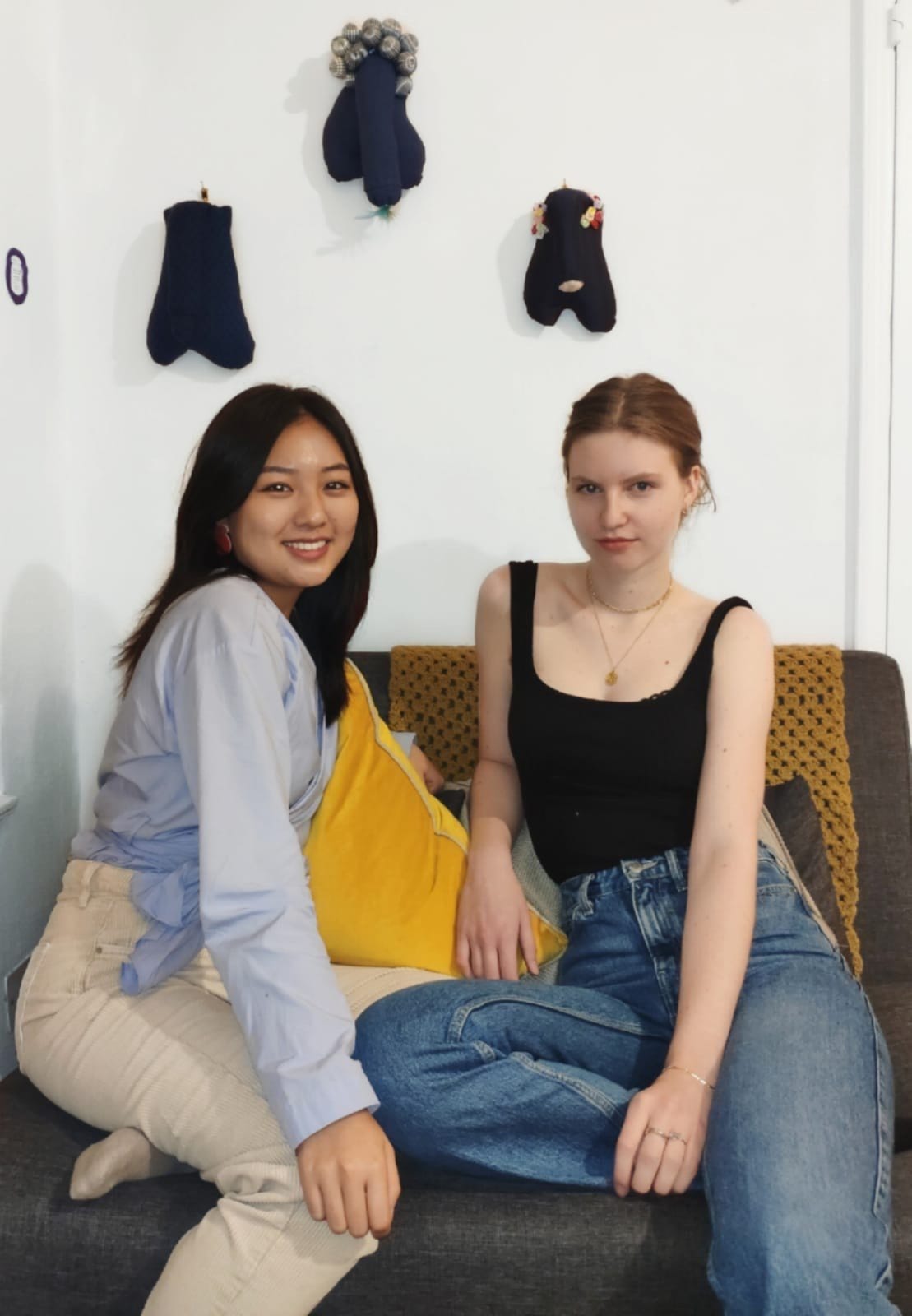 Sieun and Thea sitting below works by Cybele Troyan from The Penis Parade (London, June 2019)