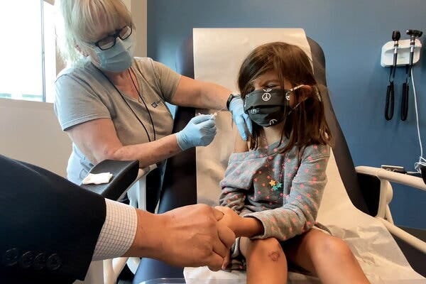 A 5-year-old receiving a Pfizer-BioNTech trial dose last month.