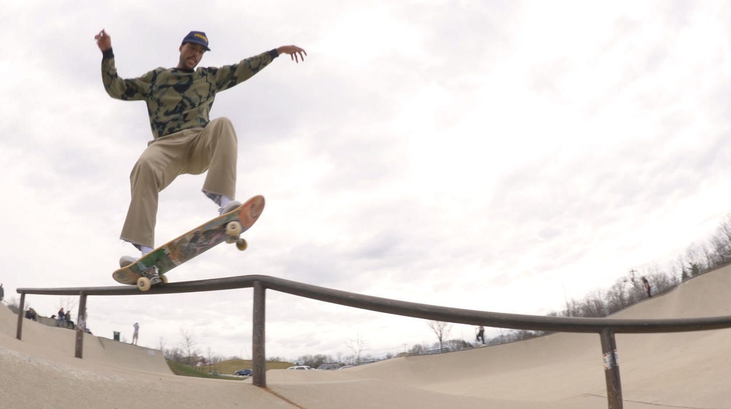 A person jumping in the air doing a trick on a skateboard

Description automatically generated