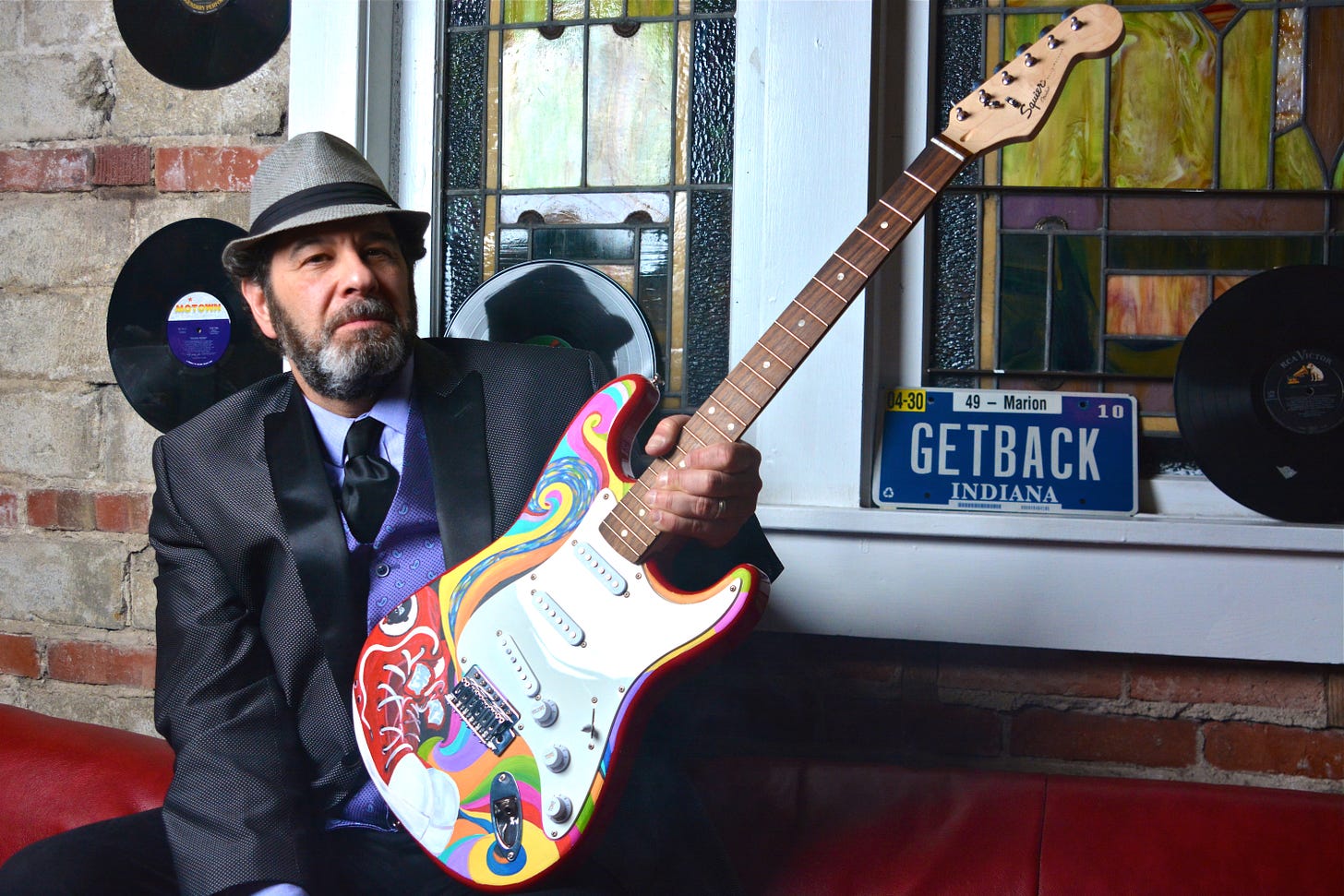 MP Cavalier holding the anonymous guitar gifted to the hosts.