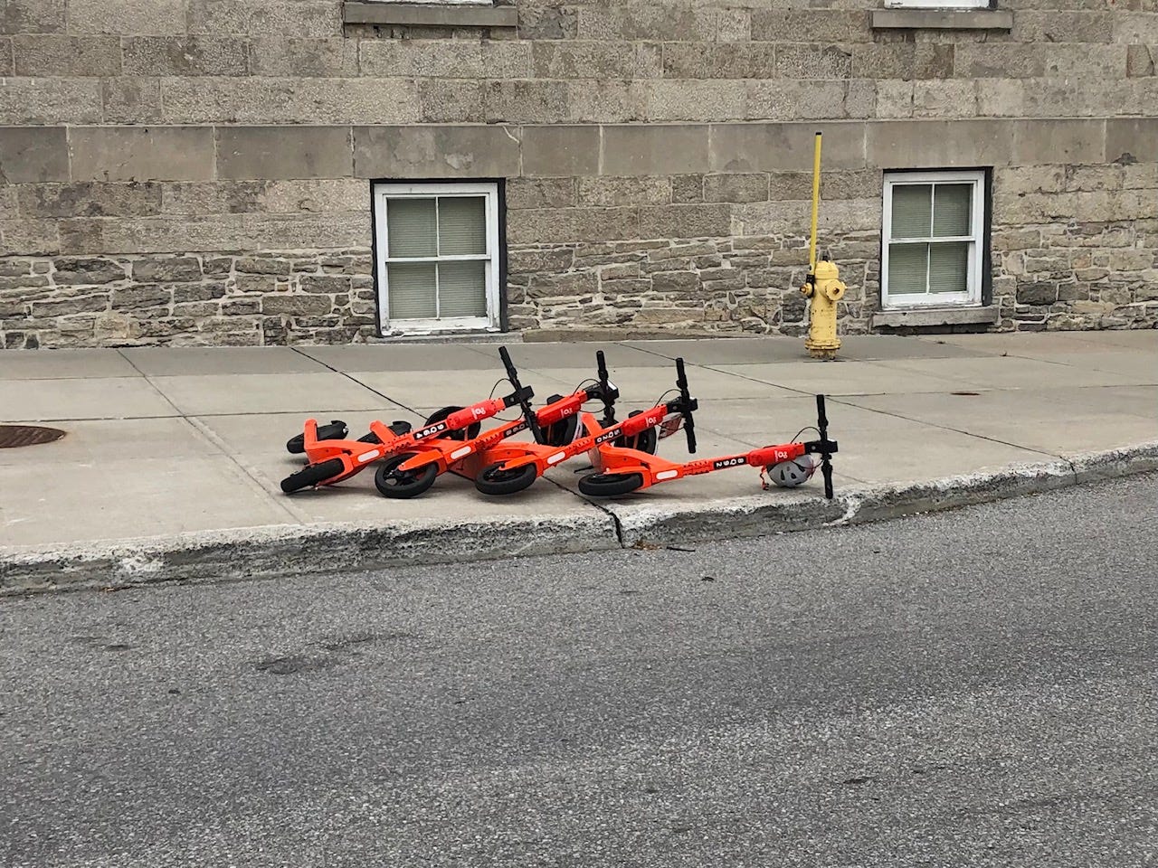 A row of e-scooters that were knocked over like dominos.