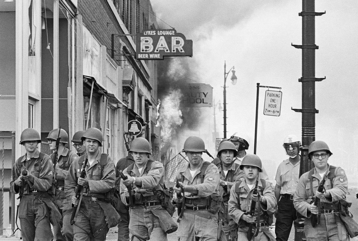 1967-Detroit: Tough-looking Michigan National Guardsmen push rioting Negroes back from a burning building with fixed bayonets on Detroit's riot-torn west side. National Guard tank crews blasted away at entrenched snipers with .50-caliber machine guns early July 26th after sniper fire routed policemen from a square-mile area of the motor city. (Getty Images/Bettmann)