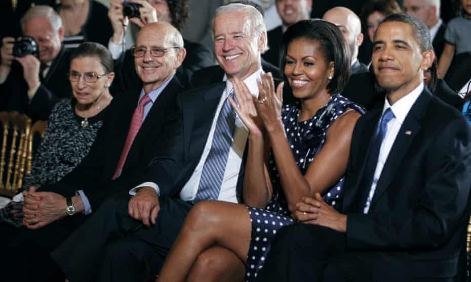 Michelle Obama sits with her husband, Barack Obama, Joe Biden, Stephen Breyer and Ruth Bader Ginsberg at the White House in 2010.