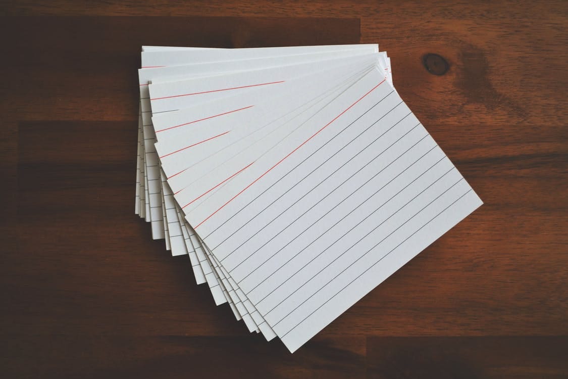 Free White Ruled Paper Lot on Brown Wooden Surface Stock Photo