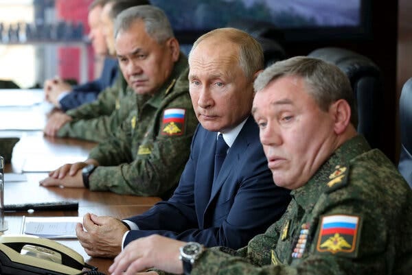 President Vladimir V. Putin of Russia, along with Sergei Shoigu, left, Russia’s defense minister, and Valery Gerasimov, the chief of staff of the armed forces, watching military exercises on Friday.