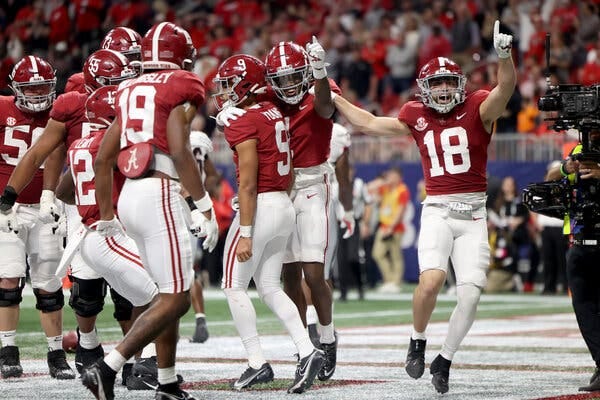 Alabama players celebrated after the quarterback Bryce Young, wearing No. 9, rushed in for a touchdown to put some distance between the Crimson Tide and top-ranked Georgia.