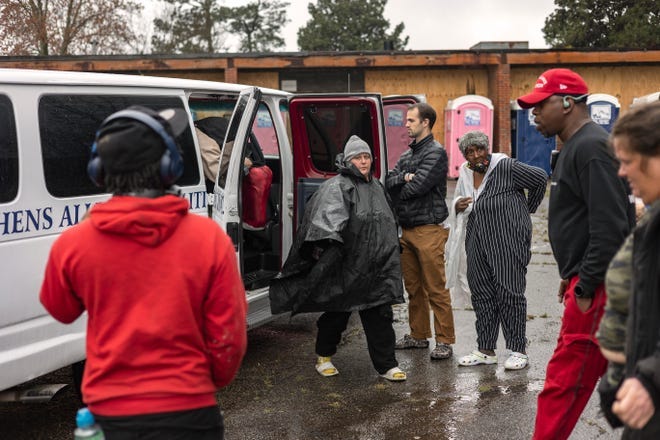 People unload their belongings during the opening day of First Step, a government-sanctioned encampment for those without permanent housing run by Athens Alliance Coalition Inc., on Wednesday, March 16, 2022, in Athens.