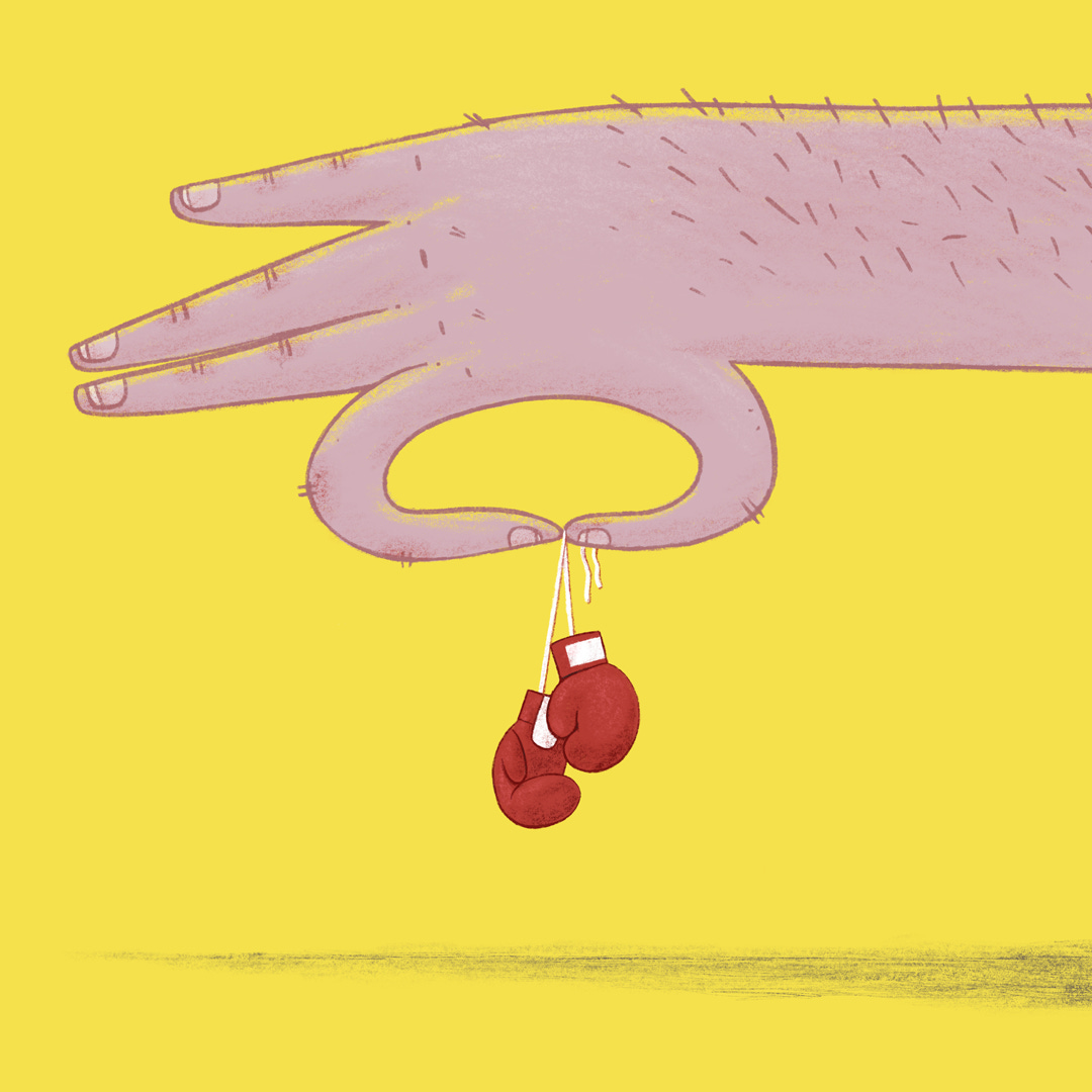A large hand holds a small set of boxing gloves A large hand holds a small set of boxing gloves