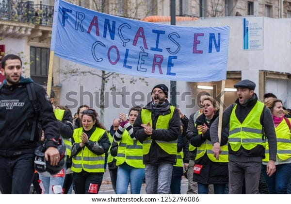 Place de la Republique, Paris, France - December 08, 2018 : Demonstrators with yellow vests ("gilets jaunes" in french) protest against the increase of fuel cost, excessive living costs