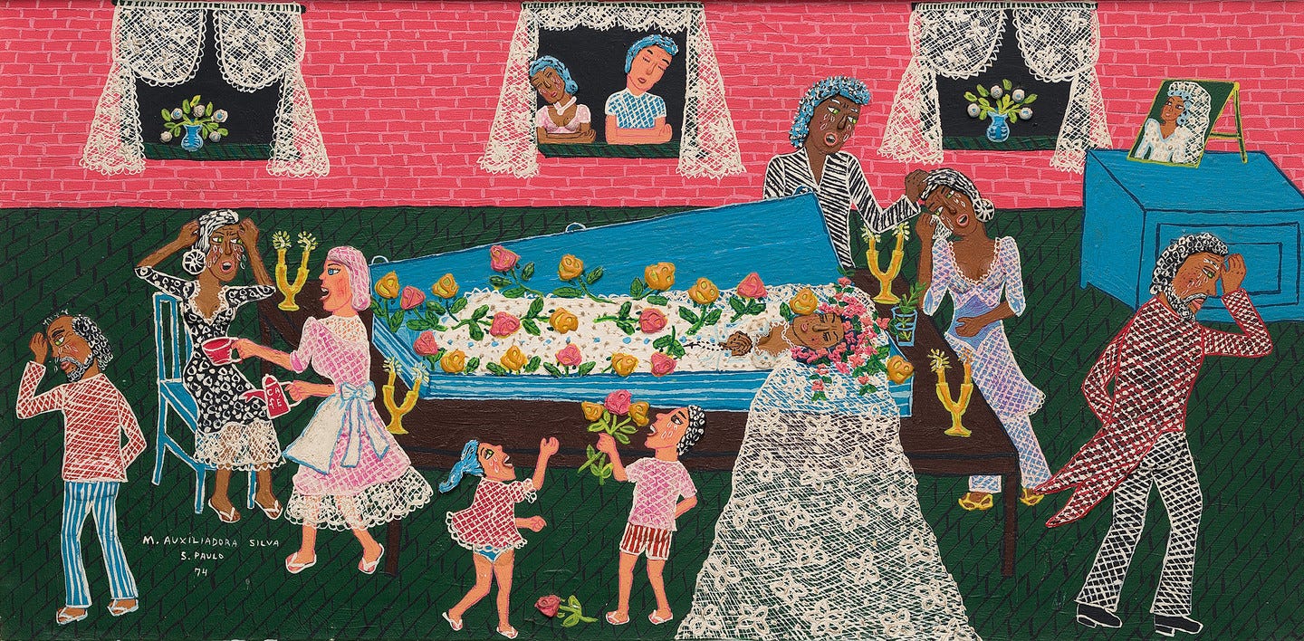 An indoor funeral scene shows a bride in a white wedding gown lying inside a blue casket with yellow and pink flowers. The mourners all around her are mostly brown skinned. Two fair skinned children stand at the foot of the casket, smiling and holding flowers. Two women stand outside a window looking into the funeral, and they look sad or in tears. The lace curtains on the windows match the veil of the bride. 
